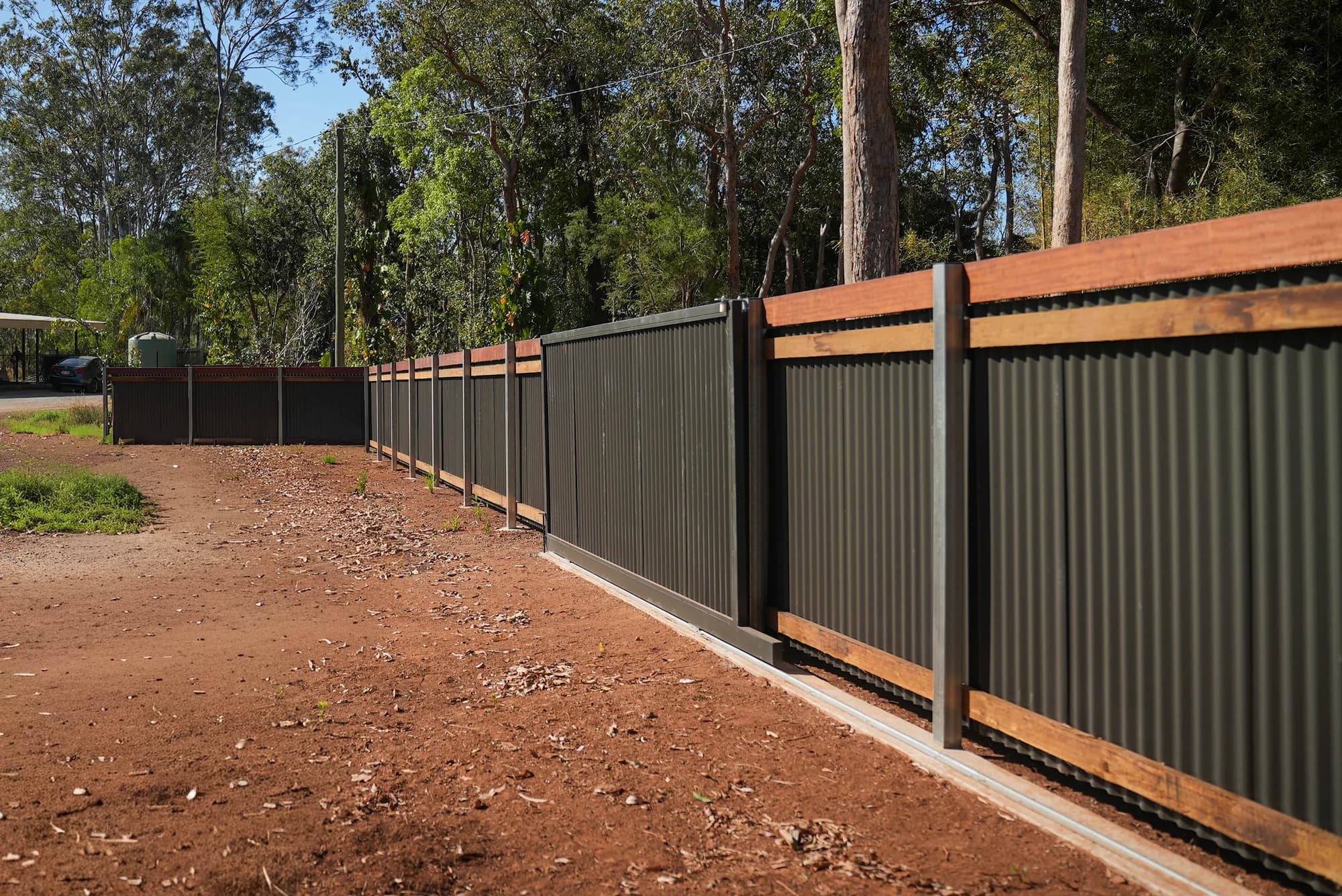Colorbond fence line with timber rail detail
