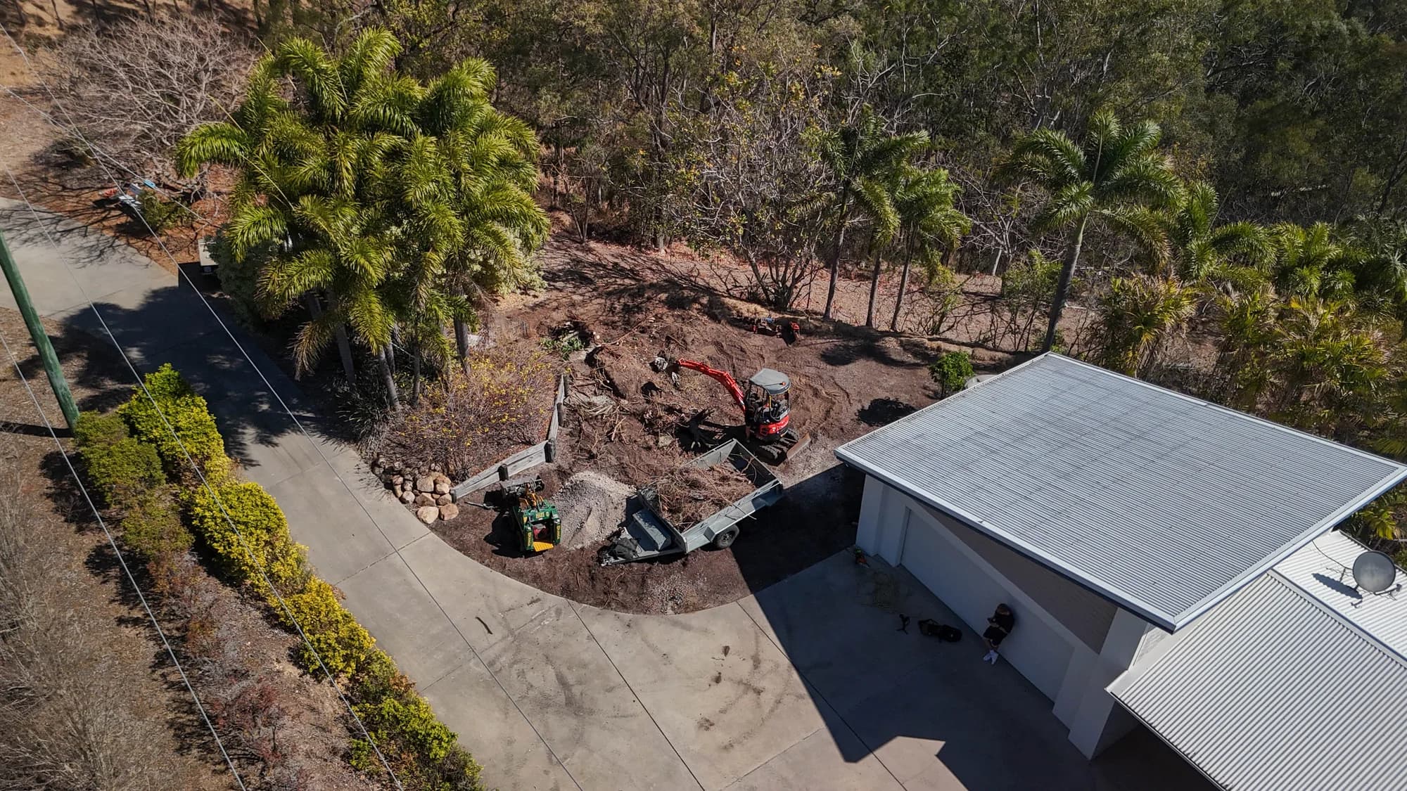 Aerial view of residential earthworks beside a home