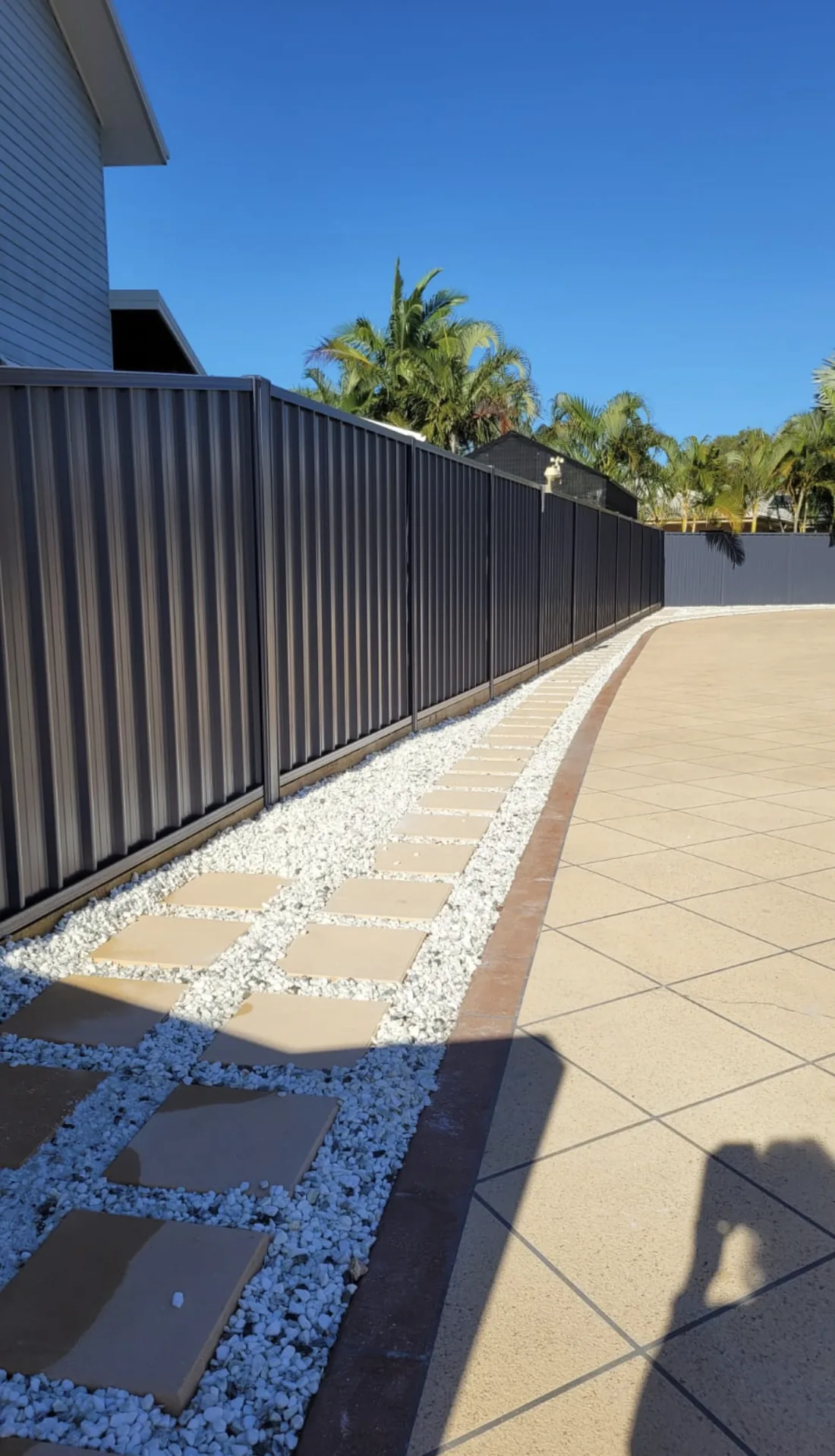 Colorbond fence and paved pathway
