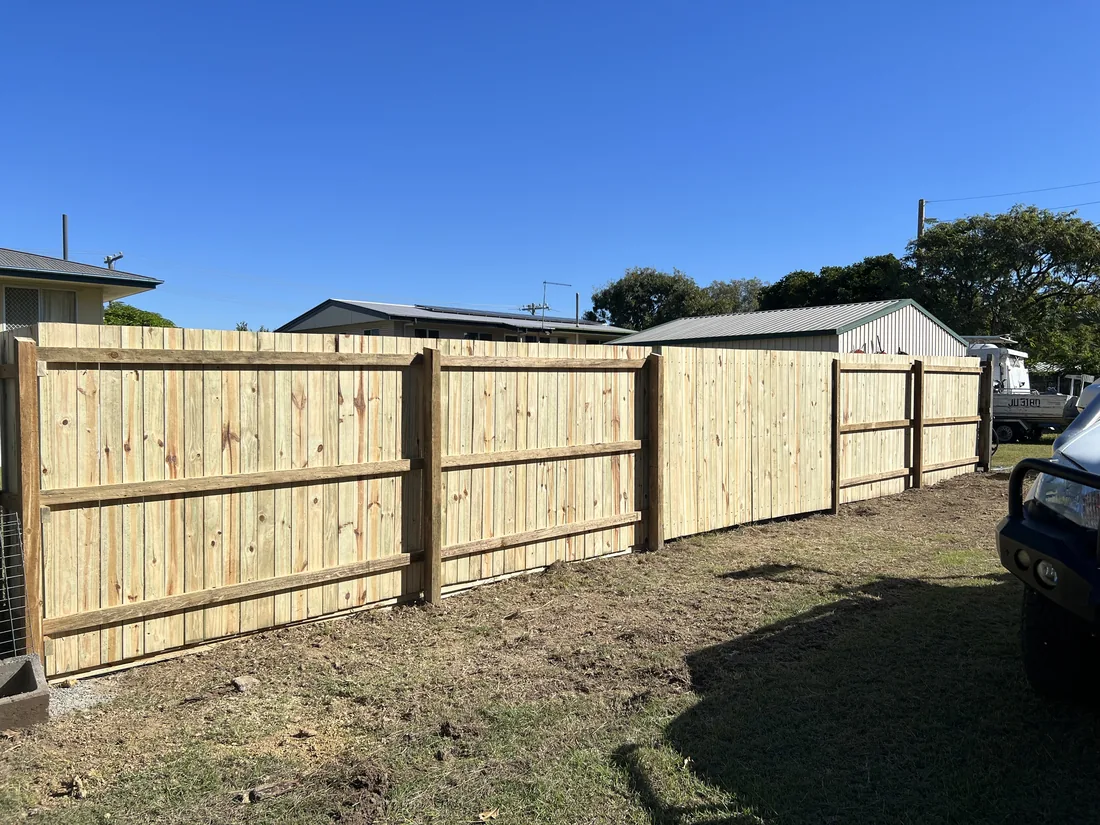 Timber paling fence with capping rail