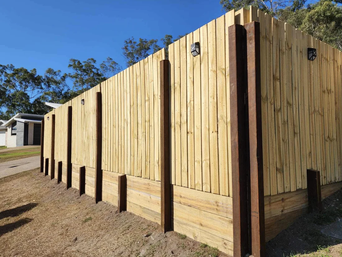 Timber fence and sleeper retaining wall